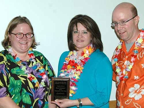 Stacy Schimmel, center, was honored as the Stewartville Area Chamber of Commerce's Volunteer of the Year for 2014 at the Chamber's annual banquet, Summer in January, at the Civic Center on Saturday, Jan. 17. Gwen Ravenhorst, Chamber administrator, left, and Robert Hruska, Chamber president for 2014, presented the award. Speaking of Schimmel, Ravenhorst said, "She comes to the table eager and willing to help out."