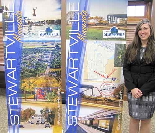 Joya Stetson, a community and business development specialist for Community &&#8200;Economic Development Associates (CEDA), of Chatfield, who works three days a week for the city of Stewartville, poses with the new retractable banners that will be on display at the Stewartville booth at the Rochester Area Builders Home Show at the Mayo Civic Center this Friday, Feb. 6 from 3 p.m. to 8 p.m., Saturday, Feb. 7 from 9 a.m. to 6 p.m., and Sunday, Feb. 8 from 11 a.m. to 4 p.m. Chris Dahle of Identity Designs of Stewartville designed the banners. Scott Gulbranson of Stewartville took the photos. 