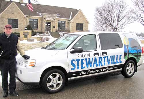 Midwest Sign Tech of Rochester recently wrapped Stewartville's city van, a 2008 Chevrolet Uplander, with advertising to promote the city. The city paid $1,420 for the work. Bill Schimmel Jr., city administrator, stood with the van in front of Stewartville City Hall last week.