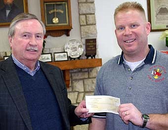 HELPING THE FIREFIGHTERS -- Jarrod Wellik, president of the Stewartville Firefighters Relief Association, right, presents a check for $34,000 in charitable gambling to Mayor Chuck Murphy, who accepted the check on behalf of the city of Stewartville.  The check represents the amount the association made in charitable gambling in 2007. The Stewartville Fire Department will use the money to purchase new equipment and replace apparatus. 