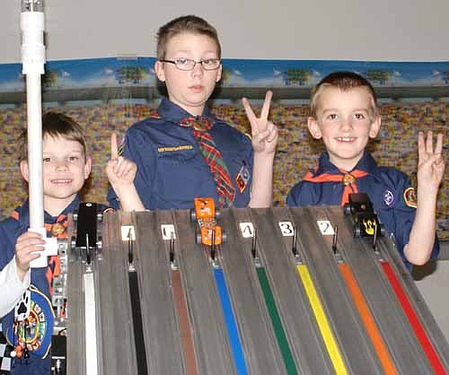 Pack 156 held its annual Pinewood Derby at Grace Evangelical Free Church on Saturday, Jan. 24. Overall winners pictured with their cars include, from left, Evan Dewhirst, first place; Robert Feine, second place; and Beau Johnson, third place.