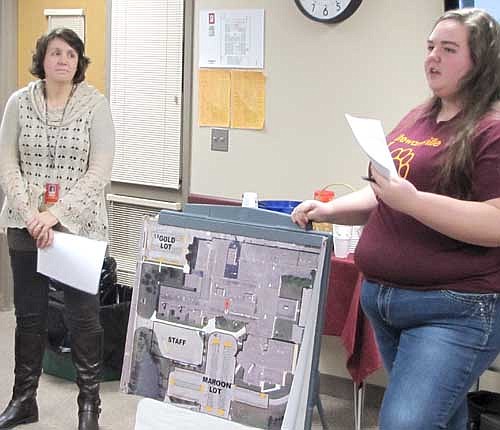 With a map of the parking lots near Stewartville High School and Middle School nearby, Olivia Oehlke, a member of the Stewartville High School Student Council, right, and Darcy Lindquist, associate principal of SHS, discuss the district's parking problems with the Stewartville School Board last week.