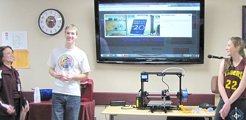 From left, Renita Irvin, media specialist for the Stewartville School District, and students Jacob West and Lori Bailey talk with the Stewartville School Board about the Stewartville School District's 3-D printer, shown at center. Other student speakers not pictured included Jacob Edholm and Sam VandeLoo.