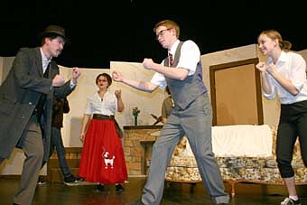 PUT UP YOUR DUKES -- Bekken Jagusch,  (Luigi Lanconi), left, and Travis Jorde (Mr. Morlock) prepare to fight as  Audra Mulleneaux (Mary Morlock), looks on in the background and Sara Zent (Jessica Morlock) right, also looks ready to fight during a dress rehearsal for Stewartville High School's upcoming presentation of "Rest Assured." 