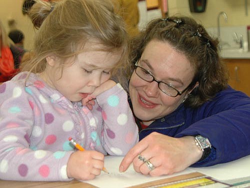Jennifer Wilcox of Stewartville helps her daughter Keagan, 4, with a drawing project at Literacy Night at Central Intermediate School on Friday, Jan. 30. Special guests included an animator, two storytellers and two illustrators. Also, hundreds of children looked for books at a book fair and book exchange. Wilcox enjoyed Literacy NIght. "It's great," she said. "It (offers) lots of ways to get the kids involved and get them thinking about reading and art."
