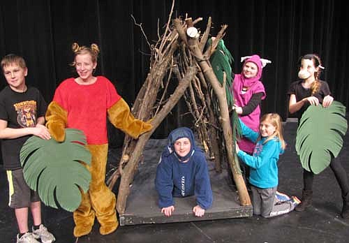 Eeyore (Katelyn McClellan) waits inside the house under construction as her friends, from left, forest animal Ethan Stone, Pooh (Ellie Fryer), Piglet (Olivia Nicklay), and forest animals Mckenna Pickett and Norah Dyke help build the house during a dress rehearsal for Stewartville Middle School's production of The House at Pooh Corner.