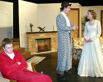 Travis Jorde (Mr. Morlock), in the foreground at right, appears perturbed as Bekken Jagusch (Luigi Lanconi) and Rachel Mann (Luigi's wife) discuss the situation during a dress rehearsal for the Stewartville High School presentation of "Rest Assured." 