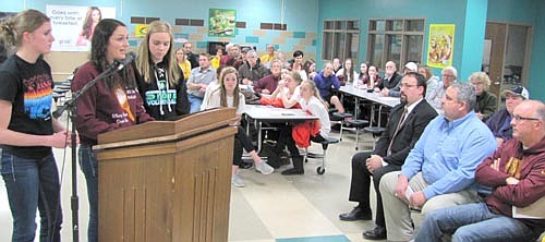 About 130 residents attended an open hearing last week to listen to allegations that Coach John Dzubay and his volleyball program violated a number of Minnesota State High School League bylaws. Tara Rogers, the captain of Stewartville's current team, standing in the center above, said that she and her teammates stand behind Dzubay 100 percent. Players Libby Christenson, left, and Karissa Kime join Rogers at the podium.