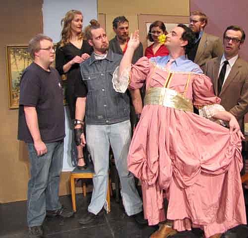 Mike (Anthony Menz) wearing the dress, claims he could play the role of the heroine in the Stewartville Community Theatre presentation of "It Runs in the Family."  The rest of the cast remains unconvinced.