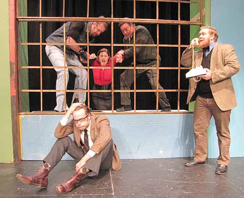 Jane (Olivia Renken), center, has slipped off the window ledge as Les (Dave Stepan), rear left, and Drake (Randy Peterson), rear right, try to hold her up during a rehearsal for the Stewartville Community Theatre production of "It Runs in the Family." David (Sean Lundberg), seated, and Hubert (Nick Rudlong), on the phone, are stuck on the other side of the window.