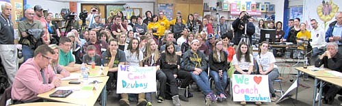 John Dzubay, far left, joins a large group of his supporters at the Central Intermediate School library media center at a March 9 meeting during which the School Board suspended Dzubay for five matches for the 2015 varsity volleyball season.