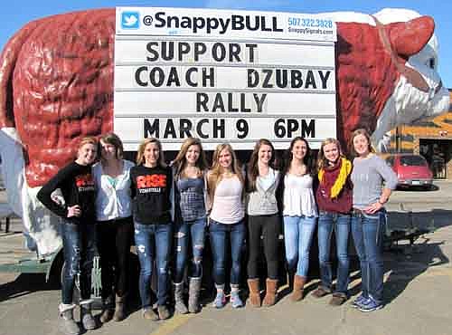 Varsity volleyball players, from left, Libby Christenson, Amanda O'Connell, Ally Schmitz, Laura Eberle, Emily Branstad, Charlie Bleifus, Tara Rogers, Karissa Kime and Jenna Willenborg show their support for John Dzubay before last week's School Board meeting.