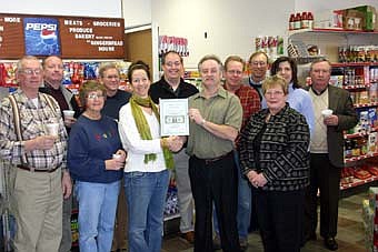 A GRACIOUS WELCOME -- The Stewartville Area Chamber of Commerce welcomed Corner Meats -N- More to the local business community with an official ambassador visit last week. Brian Ferson, the store's owner, standing at center right, accepts a "first dollar earned" plaque from Jodi Beck, Chamber administrator. Other Chamber members, standing in front from left, include Clair Mrotek and Sharon Moehnke. Standing in front at far right is Kay Tvedt, an employee at Corner Meats -N- More. Standing in back, from left, Bill Schimmel Jr., Larry Gray, Greg Schimek, Chris Gray, John Senjem, Margaret Nelson and Chuck Murphy. 