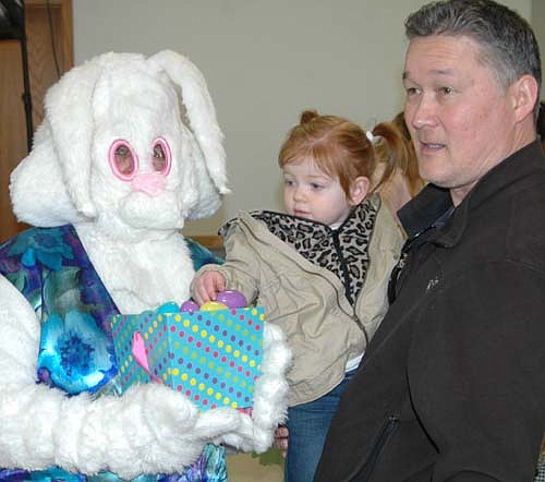 The Easter Bunny said hello to scores of children at the Stewartville Area Chamber of Commerce's Spring into Summer Marketfest at the Stewartville Civic Center on Saturday, March 28. Below, Grace Malone, 1 1/2, of Stewartville, selects an egg as her grandfather Dan Chase looks on.