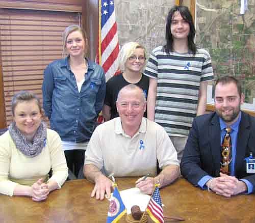 Mayor Jimmie-John King, seated in center, signed a proclamation last week declaring April "Child Abuse Prevention Month" in Stewartville. Allison Johnson, coordinator of the Olmsted County Child Resource and Referral Crisis Nursery, is seated at left. Rich Fakler of the Voices for Children Committee is seated at right. Back row, from left, are Rachael Breidall, a paraprofessional at Rochester Off-Campus Charter High School, along with Skye Keller and Carter Rasmussen, students at the Off-Campus School. The Rochester Off-Campus School partners with the Crisis Nursery to fight child abuse.