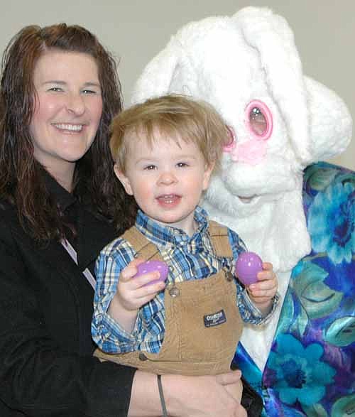 Hundreds of Stewartville and area shoppers searched for items at the Stewartville Area Chamber of Commerce's Spring into Summer Marketfest at the Stewartville Civic Center on Saturday, March 28. Above, Elyse Struckmann holds her son Jase, 18 months, during a visit with the Easter Bunny.