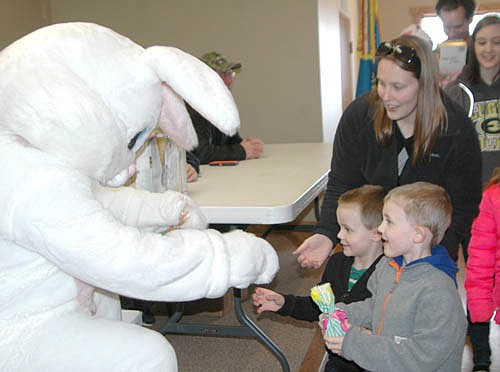 Hundreds of Stewartville and area shoppers searched for items at the Stewartville Area Chamber of Commerce's Spring into Summer Marketfest at the Stewartville Civic Center on Saturday, March 28. Above, Elyse Struckmann holds her son Jase, 18 months, during a visit with the Easter Bunny.