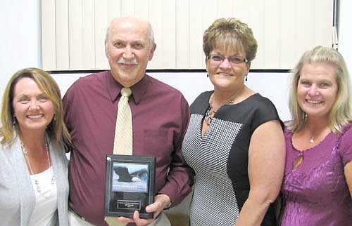 Bill Glomski, second from left, long-time geography teacher, driver's ed instructor and coach, accepts his Wall of Honor Award from, from left, Sheila McNeill, Cathy Conger and Sheila Gossman.