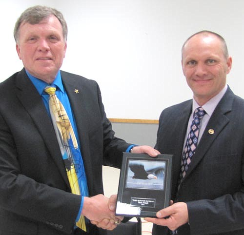 Mark Vaupel, right, who served on the Stewartville School Board for 13 years (2002 to 2014), accepts a place on the National Honor Society Wall of Honor from Dr. David Thompson, superintendent.