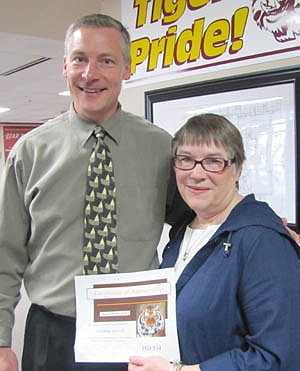 Louanne Gotch, right, accepts a Tiger Token from Matt Phelps, principal of Bonner Elementary School. Gotch reads to Bonner's students and is involved with an after-school tutoring program at St. John's Lutheran Church. "There are so many things she does," Phelps said.