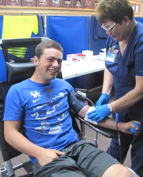 Connor Stenberg, 17, a junior at Stewartville High School, gives blood at the Mayo Clinic Blood Drive at SHS last week. Marie Mack of the Mayo Clinic assists.
