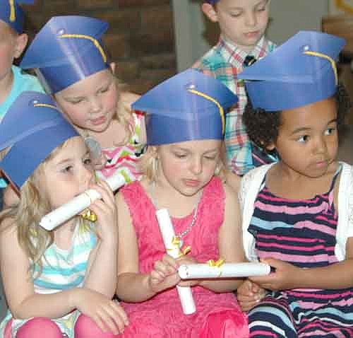 Wee Care held its annual graduation ceremony at St. John's Lutheran Church on Sunday, May 3. Graduates with their paper mortar boards and diplomas include, in front, from left, Amelia Schlager, Raina Schmeling and Lillian Wodele; and in back, Emily Nelson.