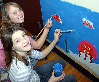 ARTISTS UNDER THE SEA -- In keeping with the Stewartville School District's "Fish" philosophy, Nora Luskey's art students, including fifth-graders Darian Kruegel, foreground, and Amanda Jaeger, began painting undersea scenes on Central Intermediate School's lower walls last week.  The "Fish" philosophy encourages the district's teachers and staff members to "make their day," "be present," "choose your attitude" and "play." 