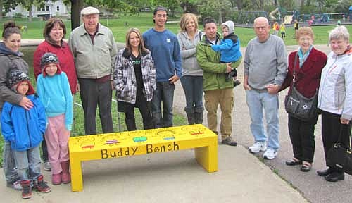 Members of Mackenzie Higgins' family stand near the Buddy Bench dedicated in Mackenzie's memory near the playground at Central Intermediate School on Monday afternoon, May 18. Pam Higgins, Mackenzie's mother, standing fourth from left, thanked Stewartville school officials for honoring her daughter. "I'm just overwhelmed," she said. 