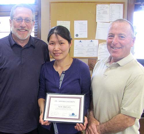 Amanda Zheng, center, who started the New Hunan Chinese restaurant with her husband, Kevin Dong, in December 2011, accepts a certificate of appreciation from Chris Stafford, president of the Stewartville EDA, left, and Mayor Jimmie-John King, also an EDA member.