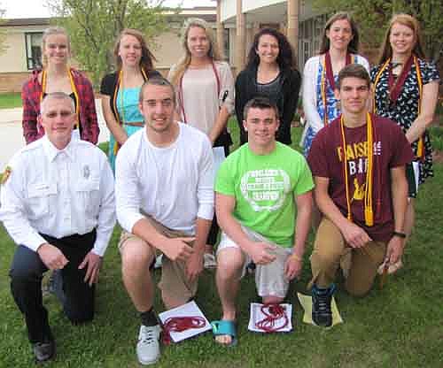 The Stewartville Fire Department has awarded $1,000 college scholarships to each of 10 members of the Stewartville High School class of 2015. Jeff Olson of the Stewartville Fire Department, kneeling at far left in front, announced the names of the scholarship recipients at the SHS Academic Awards Assembly on Friday, May 1. Students who earned the scholarships include, front row, starting from second from left, Conner Hanf, Collin Fanton and Tom Lewis. Back row, from left, Katie Paschal, Ashley Black, Amanda Jaeger, Jordenne Huinker, Lauren Mikel and Madisen Hart. Also, Brady Keefe, another scholarship recipient, is not pictured.