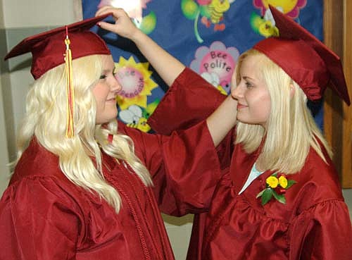 Just as Cassandra Drees, left, and Megan Ellinghuysen adjusted each others' mortarboards before the commencement ceremony for the Stewartville High School class of 2015 last Friday, May 29, so the 120 graduates in this year's class will adjust to the new lives that await them after high school. Joe Waugh, the featured speaker at this year's ceremony, advised the graduates to laugh at and learn from any mistakes they may make along life's journey.