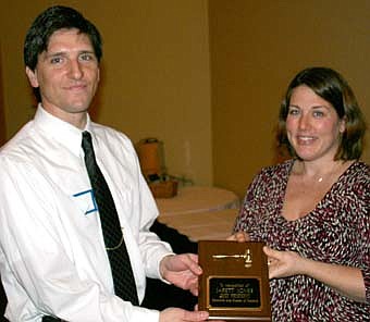 THE NEW PRESIDENT -- Jarett Jones, Stewartville Area Chamber of Commerce president for 2007, left, passes the president's gavel to Dr. Stephanie Lillis, who takes over as the organization's president in 2008. 