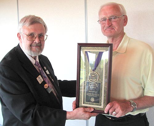 Darrel Jaeger, right, earned the Hearing Foundation Award from the Stewartville Lions Club. Jaeger accepted the award from Stan Nerhaugen, district governor-elect, at Riverview Greens last week.