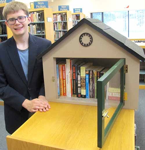 Sam Edge, a page at the Stewartville Public Library, displays the new mini library that will be placed on the lawn of a Stewartville home this fall. Residents interested in being the host family for the mini library may enter their name in a drawing at the Stewartville Public Library this summer. "We'll take names throughout the summer," said Deb Lofgren, associate librarian. "(The mini library) will be installed by this fall."