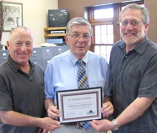 George Sedgwick, veterinarian at the Stewartville Animal Clinic, center, accepts the EDA's Business Appreciation Award from Mayor Jimmie-John King, left, and Chris Stafford, president of the EDA.
