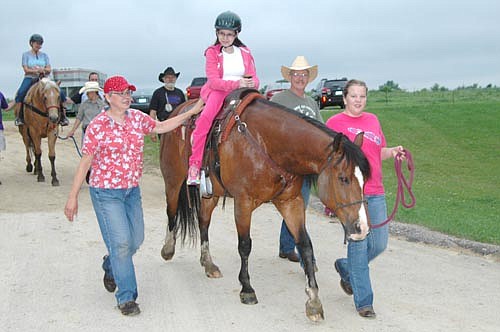 Taylor Dumke of Wesley Chapel, Florida, rides a horse at the National Wheelchair Sports Camp at Ironwood Springs Christian Ranch on Monday, June 15. Taylor is one of 70 campers with disabilities who enjoyed many activities, including tennis, softball, scuba diving and more. 