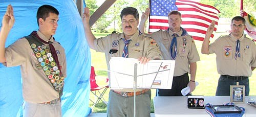 Scoutmaster Mark Ross, second from left, was one of the hosts at a Court of Honor ceremony to salute David Rysted, left, as a new Eagle Scout at Brin Park in Stewartville on Saturday, June 20. Above, Ross invites David Rysted to affirm his allegiance and fellow Eagle Scouts Darin Horstman, second from right in the background, and Steven Rysted to reaffirm their allegiance to the three promises of the Scout Oath.