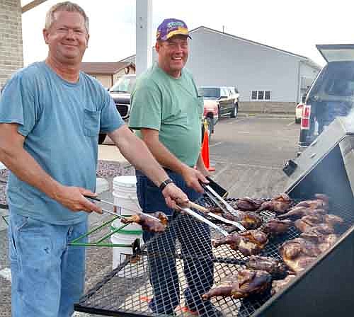 Mike Quandt, left, and Norm Howe cooked the chicken for the Sons of the American Legion chicken barbecue on Saturday, June 27. The Sons of the American Legion hope to make the barbecue, which also included live music, an annual event.