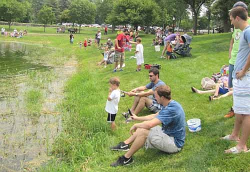 Matt Terhaar, seated in the foreground, joined scores of other fishermen at the annual Summerfest Fishing Contest.