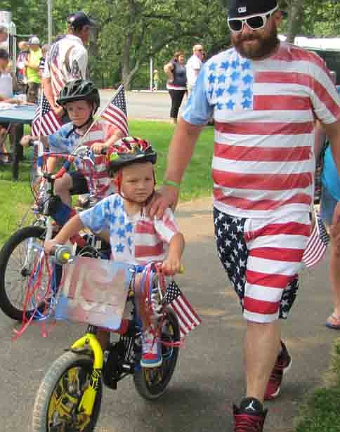 Micah Truax, 7, and his younger brother Mauer Truax, 4, joined their dad in patriotic dress for the Stewartville Area Chamber of Commerce Children's Parade.