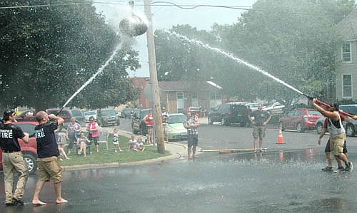 The Stewartville Fire Department's youth and adult water fights entertained an audience that not only enjoyed the fun event, but also benefited from the effects of the cool mist during the heat of the day.