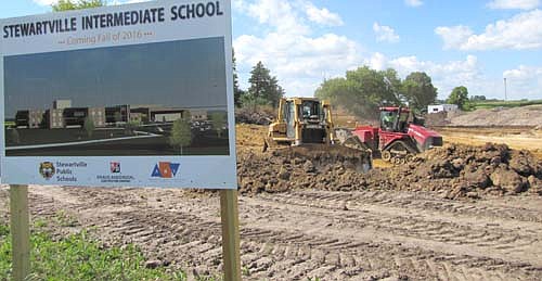 Workers have begun moving dirt to pave the way for a new school for third, fourth and fifth graders at a 30-acre site just north of Bear Cave Park. The Stewartville School Board, at a meeting in late June, approved hiring Edge Contracting, Inc. of Elgin, Minn. to complete utility and earthwork on the project for $1,167,000.  At that same meeting, the School Board unanimously accepted bids from a number of companies that will build the $24.6 million, 95,000 square foot, two-story structure. Justin "J.J." Webster of Kraus-Anderson of Rochester, the construction manager for the project, has said that it will take about 13 months to build the school, which is scheduled to open in fall 2016.