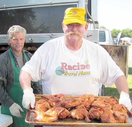 Joe Dee of the Racine Lions Club displays a few of the 500 chicken halves the Lions served at the 31st annual Racine Lions Club Chicken Barbecue and Dance at Racine City Hall on Saturday, July 18. Scott Hurley, owner of Parties Made Simple, in the background at left, cooked the chicken.