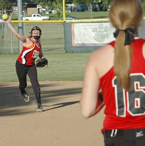 Rebel shortstop Callie Fischer charges and scoops a Winhawk grounder to make the relay to Kait Augustin covering first base on the play.  The Rebels lost both games hosting a doubleheader against Winona.