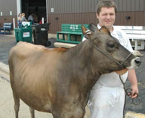 George Skare of the HIgh Forest Chippewa Champions, who will be a senior at Stewartville High School in about two weeks, showed Chandra, a fall yearling Jersey, at this year's Olmsted County Fair. Chandra was  the grand champion Jersey at last year's County Fair and qualified for the Minnesota State Fair. Skare says he very much enjoys showing animals at the Fair. "It's so fun, especially when you get the ribbon you've been hoping for," he said. "There's no words to explain how that feels."