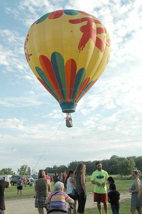 People stood in long lines to ride in a tethered hot air balloon at the Miracles Happen Festival on Saturday, July 25.