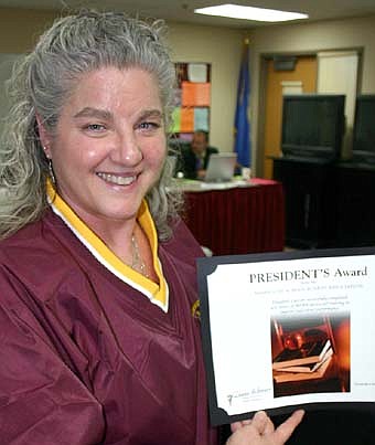 AWARD WINNER -- Beth Lawson, chair of the Stewartville School Board, displays the President's Award she recently earned for putting in 300 hours of Minnesota School Board Association-sponsored training to improve her individual performance on the board.  
