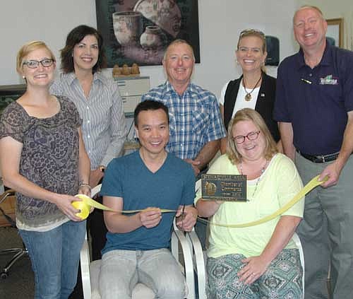 Members of the Stewartville Area Chamber of Commerce welcomed A+ Nails Professional Nail Care to the Chamber with an official ambassador visit on Wednesday, July 29. Tri Nguyen, owner and manager of A+ Nails, seated in front, cuts the ribbon celebrating the official opening of his business and accepts a Chamber plaque from Gwen Ravenhorst, Chamber administrator, seated at right, and Melissa Sue Leuning, Chamber president, standing at left in front. Other Chamber members who welcomed Nguyen include, standing in back, from left, Margaret Nelson, Mayor Jimmie-John King, Beth Schmidt and Bill Schimmel Jr., city administrator. A+ Nails, which is located in the Johnson Building on Main Street, had a soft opening on June 5. "It's going good," Nguyen said. "A lot of people have been coming in and returning."