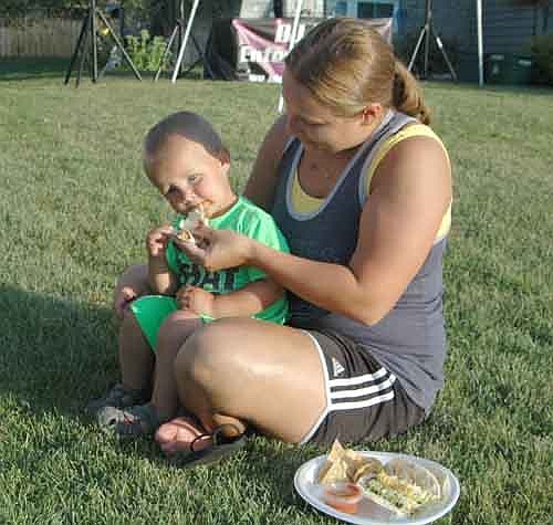 Andrea Iverson and her son Blake, 1 1/2, enjoyed some Mexican food as they joined their neighbors at the 600 block of Twelfth Avenue Northeast for National Night Out last Tuesday, Aug. 4.