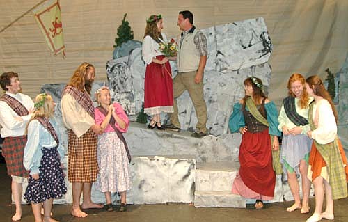 Fiona (Lisa Modry), left center, is falling in love with Tommy (Anthony Menz), right center, as the town gossips below them in a dress rehearsal for the Stewartville Community Theatre's production of Brigadoon, which will continue at the Stewartville High School Performing Arts Center this Friday, Aug. 15 and Saturday, Aug. 15 at 7:30 p.m. each evening, and this Sunday, Aug. 16 at 2 p.m.